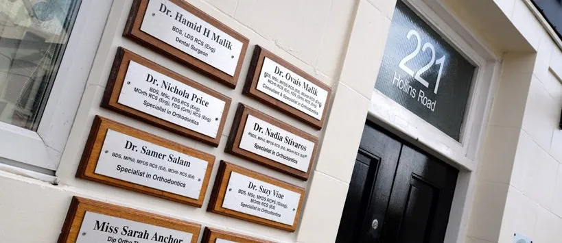 The Specialist Orthodontist nameplates outside Oldham Orthodontics on Hollins Road