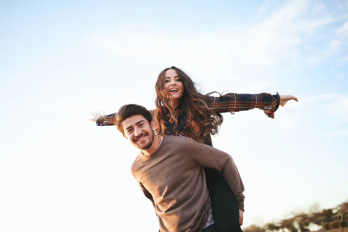 An adult patient smiling outdoors