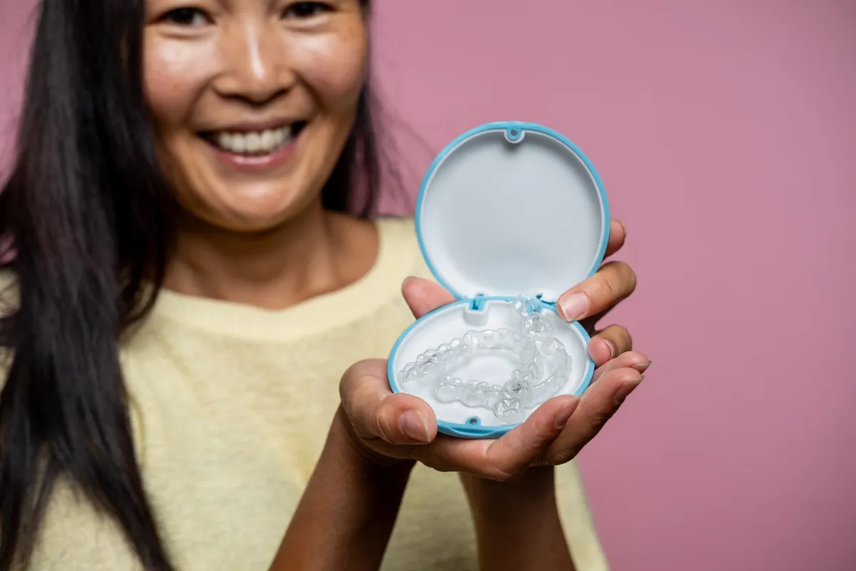 A patient holding her ClearCorrect aligner case