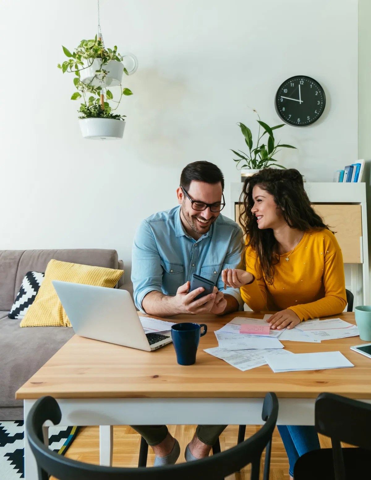 A couple reviewing finance paperwork together at home