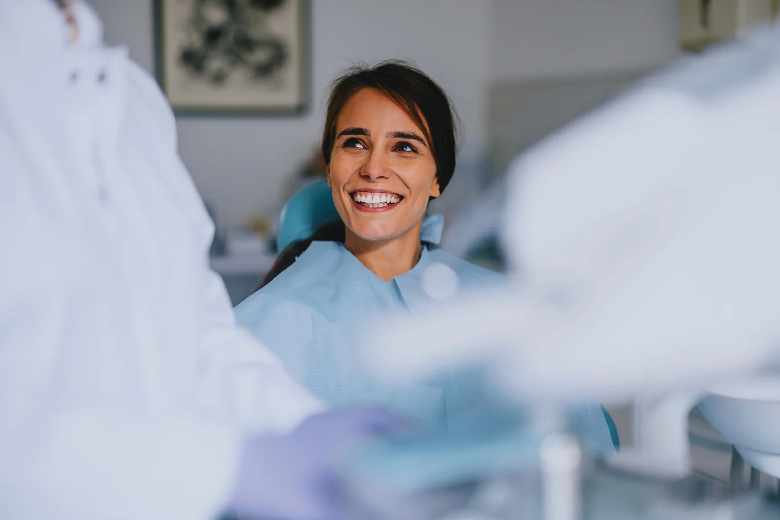A patient smiling during a consultation in the dental chair